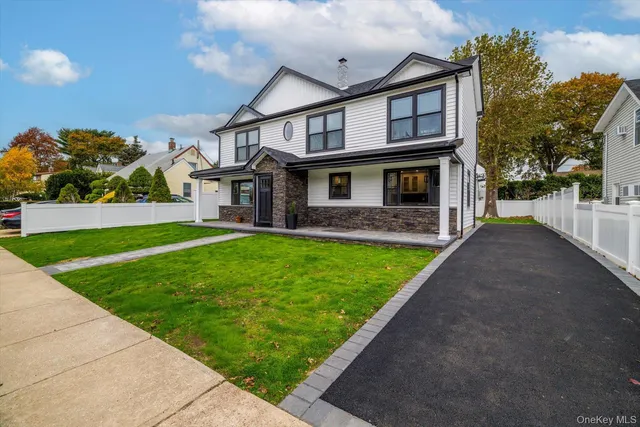 a front view of a house with a yard and porch