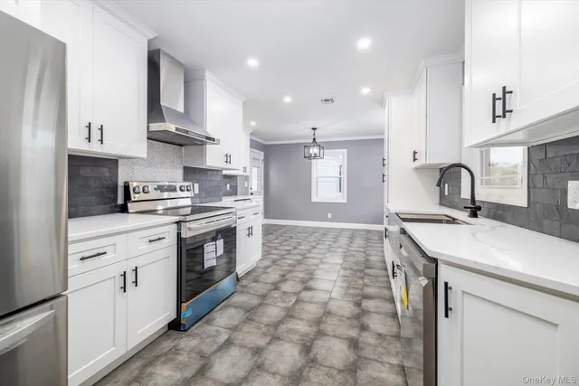 a kitchen with stainless steel appliances a sink stove and cabinets
