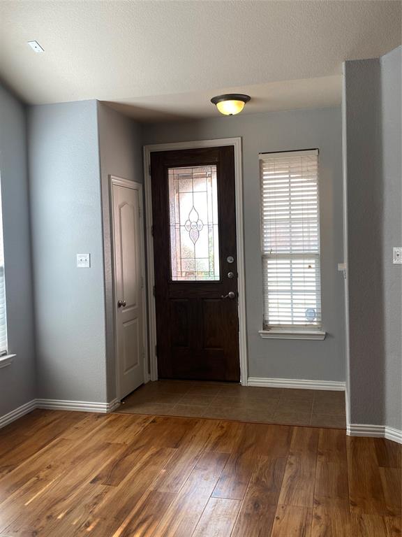 1708 Adams Place Prosper, TX 75078 - Photo 2 of 13 an empty room with wooden floor and windows