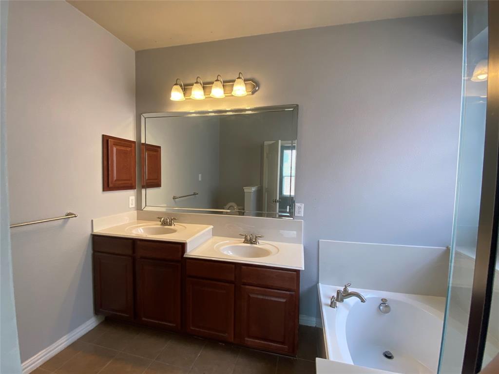 1708 Adams Place Prosper, TX 75078 - Photo 7 of 13 a bathroom with a sink and a mirror