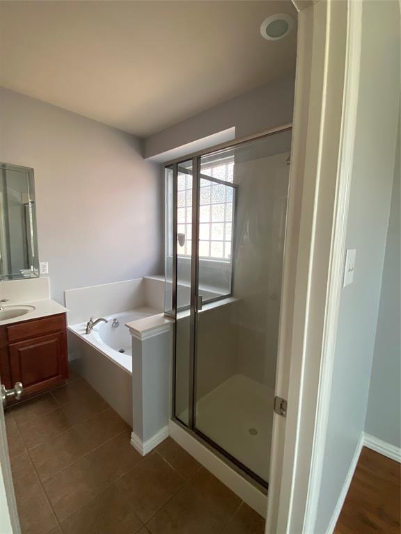 1708 Adams Place Prosper, TX 75078 - Photo 8 of 13 a bathroom with a tub a sink and mirrors