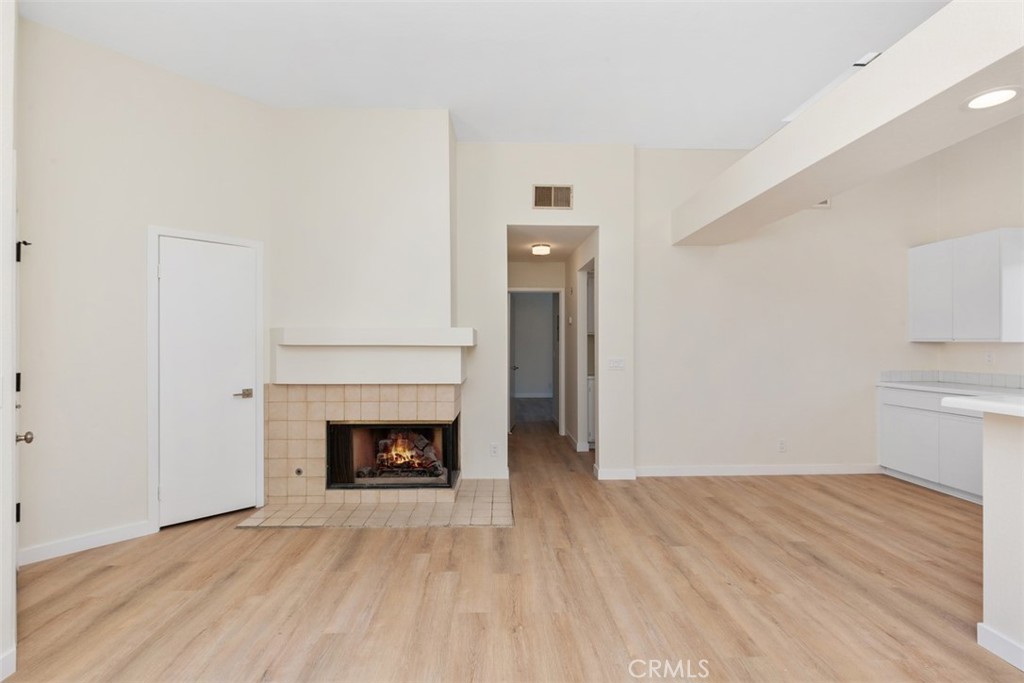 85 Pearl Laguna Niguel, CA 92677 - Photo 4 of 35 a view of an empty room with wooden floor and a fireplace