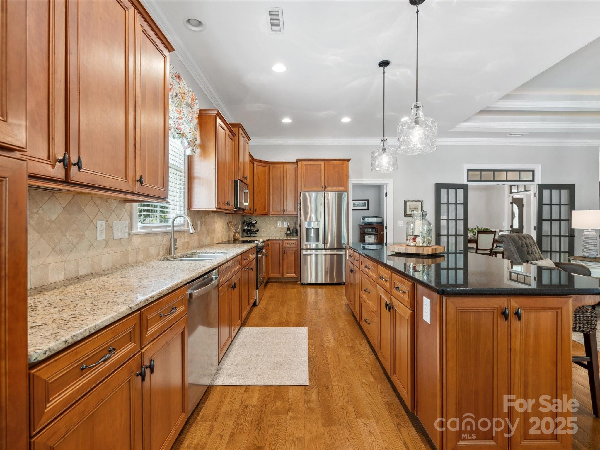 894 Stratford Run Drive Fort Mill, SC 29708 - Photo 14 of 45 a large kitchen with stainless steel appliances granite countertop plenty wooden cabinets counter space a sink and a window
