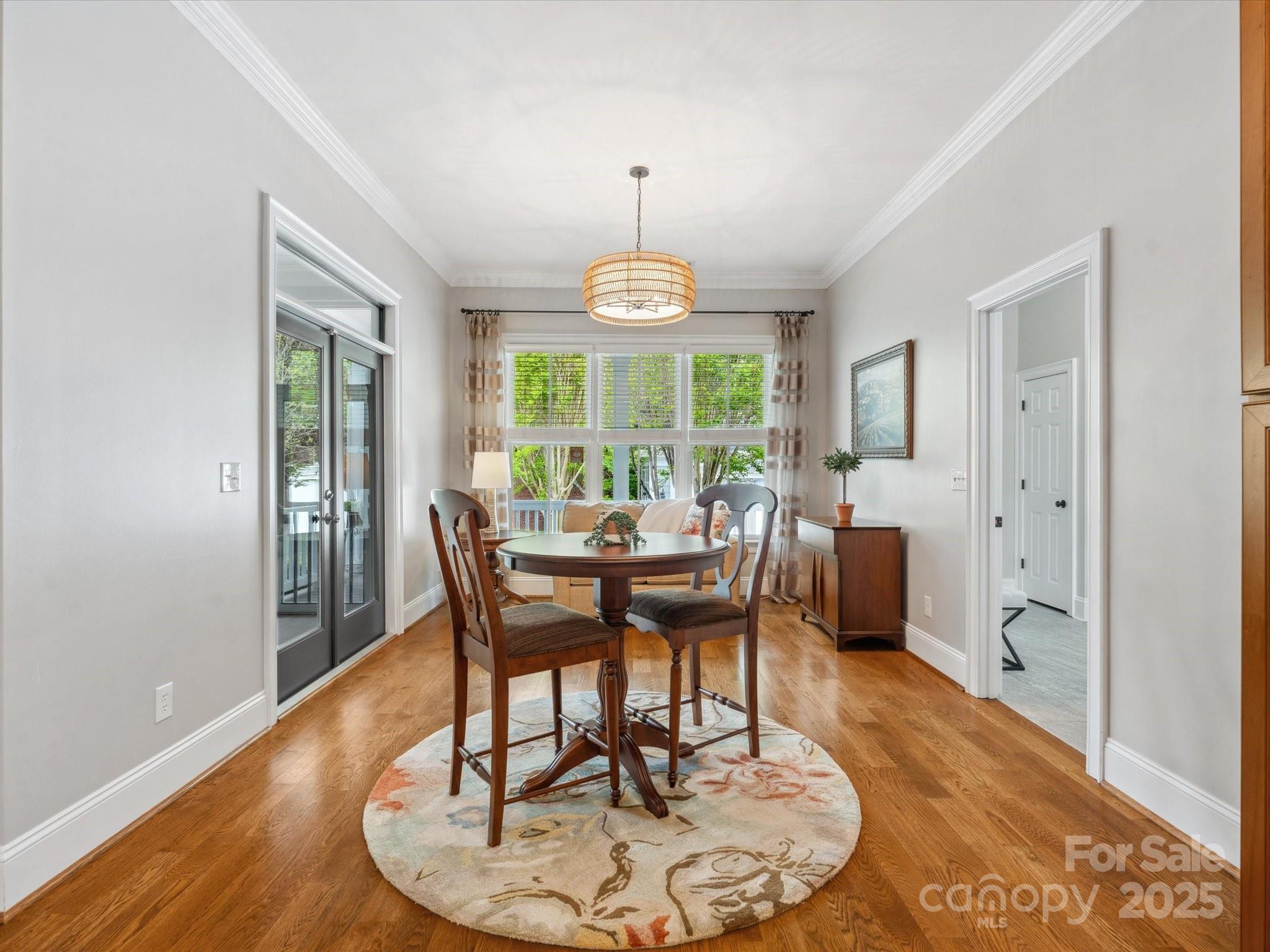 894 Stratford Run Drive Fort Mill, SC 29708 - Photo 18 of 45 a dining room with furniture a chandelier and wooden floor