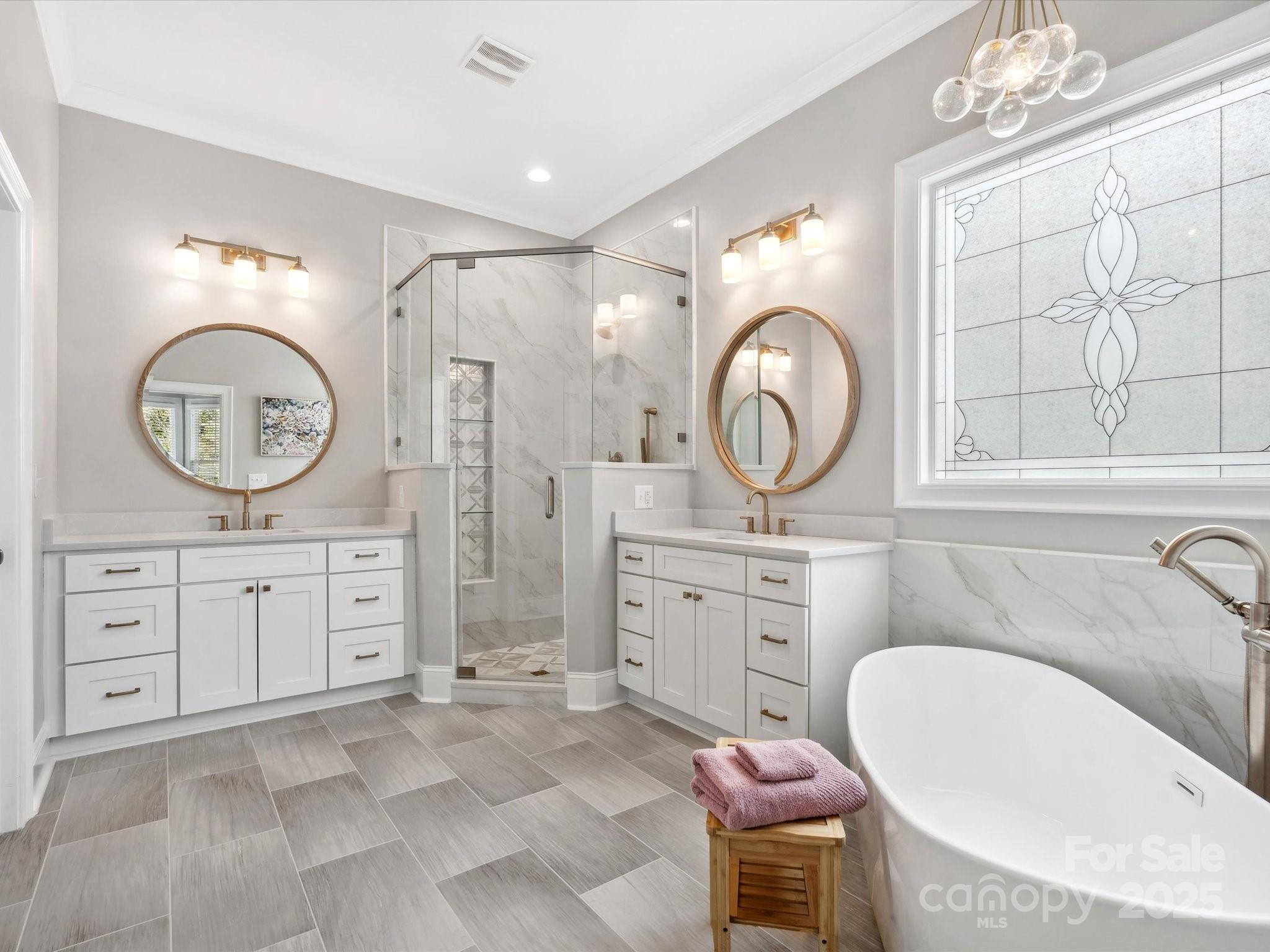 894 Stratford Run Drive Fort Mill, SC 29708 - Photo 24 of 45 a bathroom with a granite countertop double vanity sink a mirror a bathtub and a window
