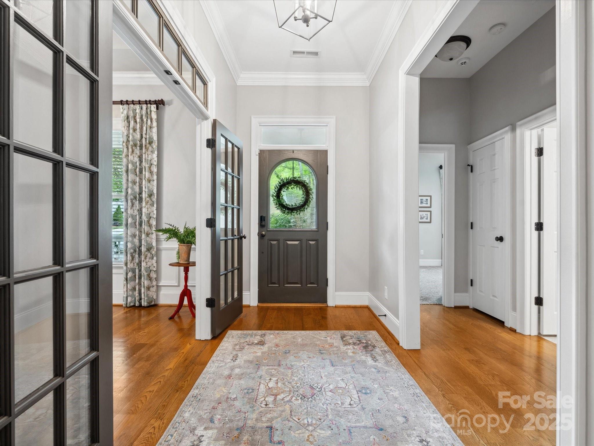 894 Stratford Run Drive Fort Mill, SC 29708 - Photo 3 of 45 a view of a hallway with wooden floor and dining room