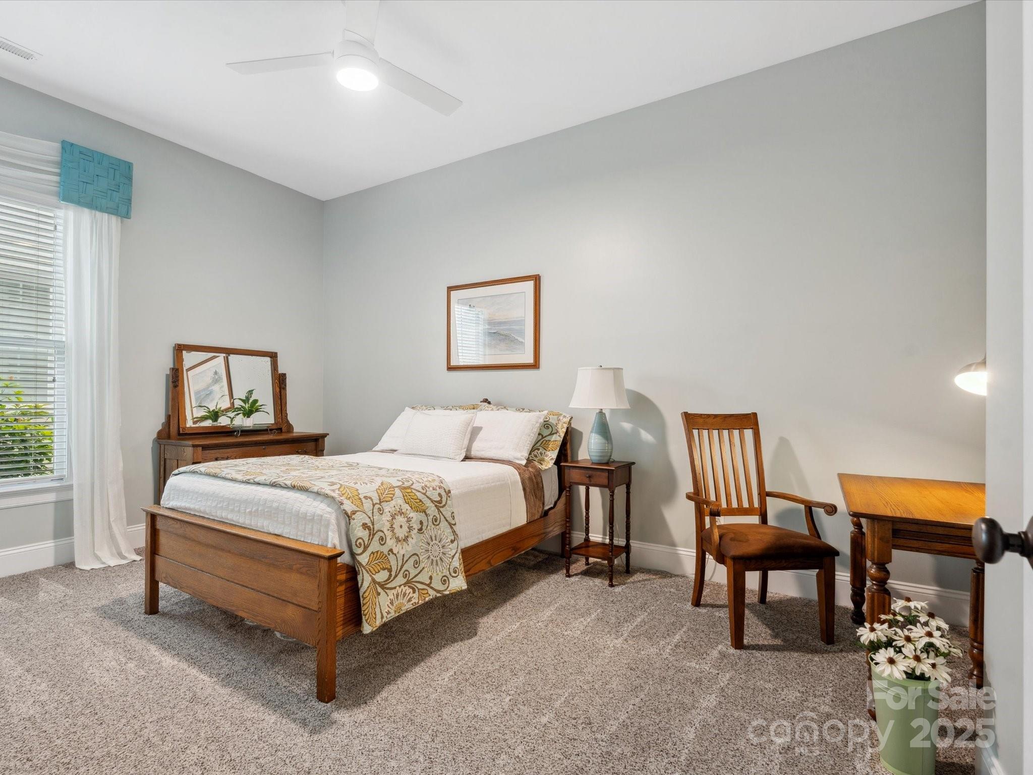 894 Stratford Run Drive Fort Mill, SC 29708 - Photo 8 of 45 a bedroom with a bed a lamp and a window