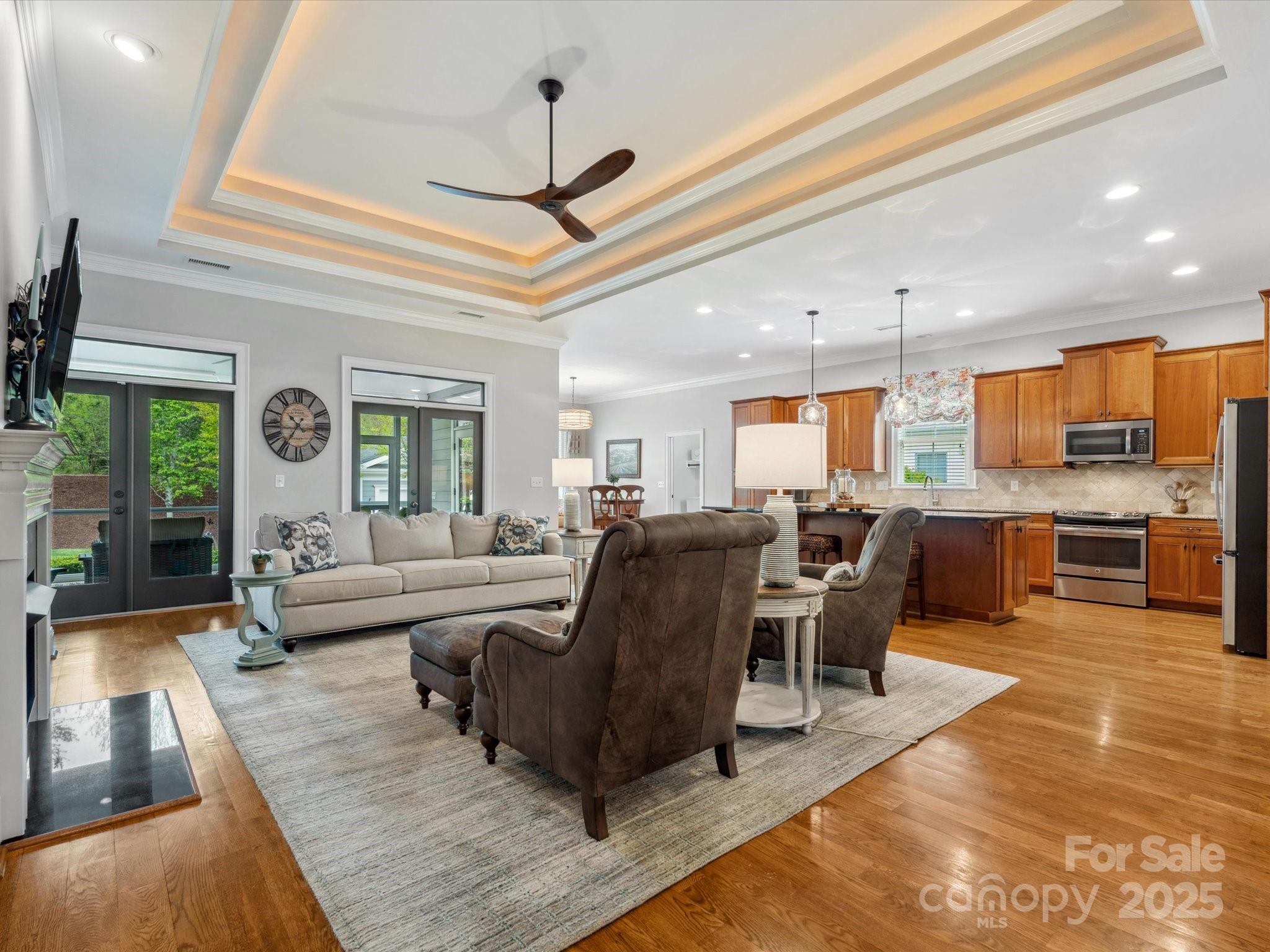 894 Stratford Run Drive Fort Mill, SC 29708 - Photo 9 of 45 a living room with furniture kitchen view and a chandelier