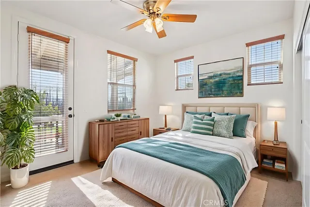 a bedroom with a balcony a bed and a chandelier