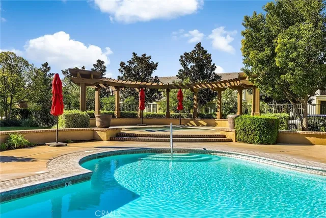 a view of a house with swimming pool and sitting area