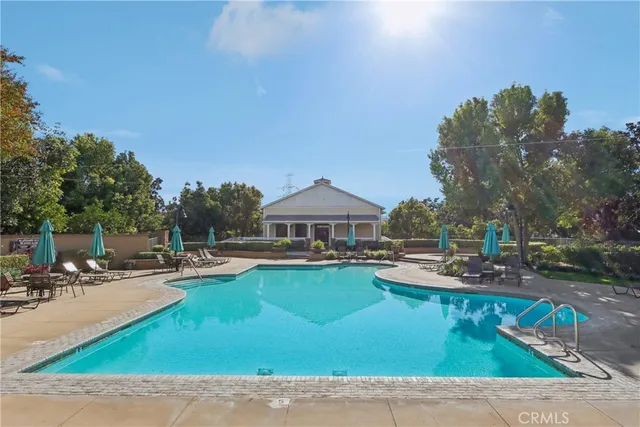 a view of a house with swimming pool and sitting area