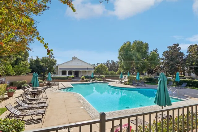 a view of a house with backyard patio and swimming pool