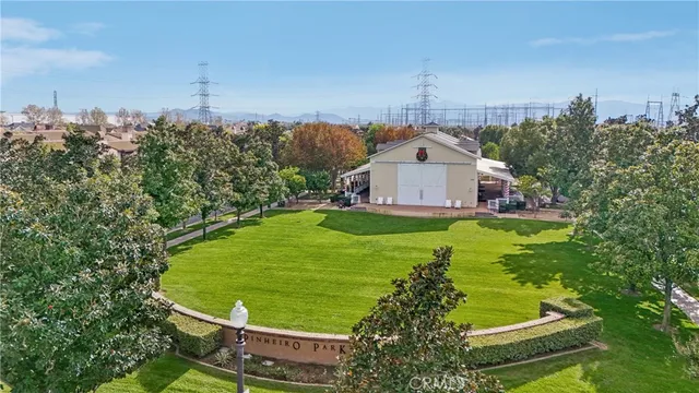 a view of a white house with a big yard and large trees
