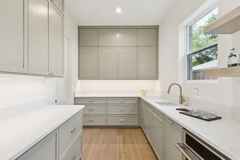 a kitchen with a sink stove and cabinets