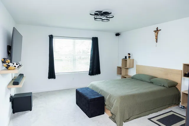 a bedroom with a bed and a window