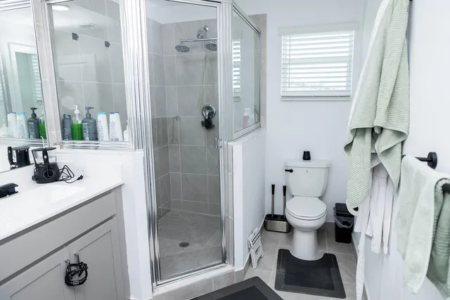 a bathroom with a sink toilet and shower