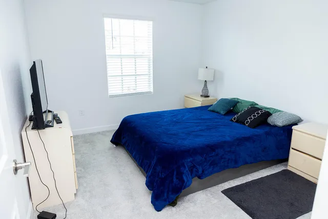 a bedroom with a bed and a window