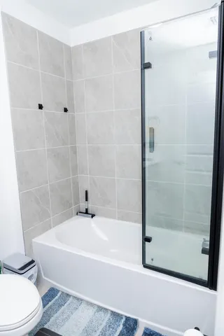 a bathroom with a bathtub and a shower