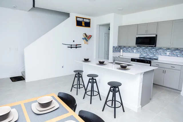 a kitchen with a table and chairs in it