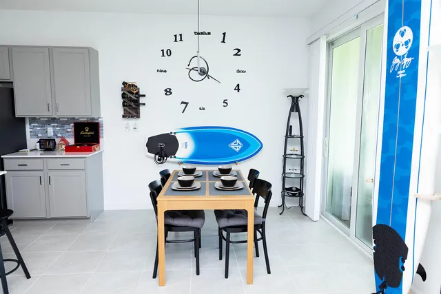 a kitchen with stainless steel appliances kitchen island a table and chairs in it
