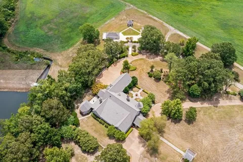 an aerial view of a house with a garden and swimming pool