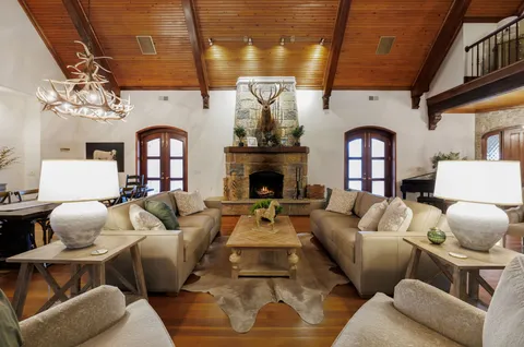 a room with pool table and windows