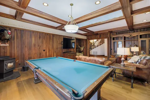 a view of a hallway with wooden floor and stairs