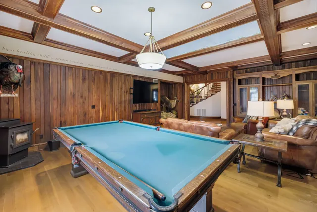 a view of a hallway with wooden floor and stairs