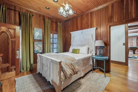 a kitchen with stainless steel appliances kitchen island a table chairs in it and wooden floors