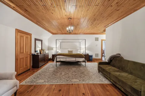 a spacious bedroom with a bed and a couch