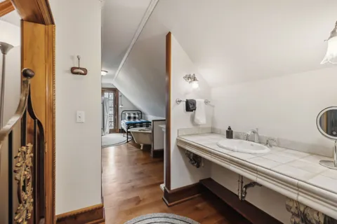 a view of a balcony with furniture and wooden floor
