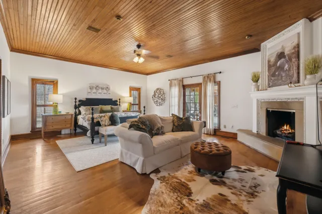 a kitchen with lots of wooden cabinets appliances and furniture