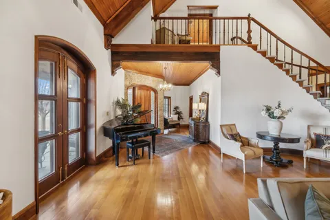 a living room with furniture and a chandelier