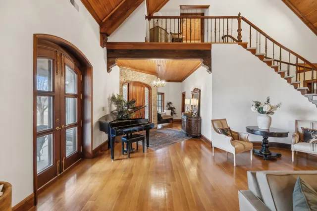 a living room with furniture and a chandelier
