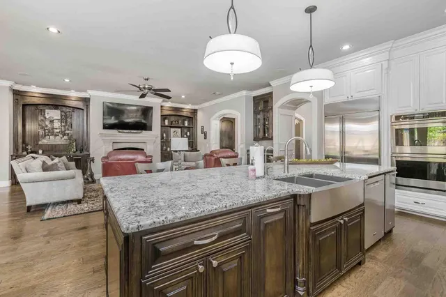 a view of living room with kitchen island furniture and flat screen tv