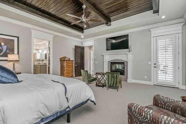 a spacious bedroom with a bed a fireplace and a couch