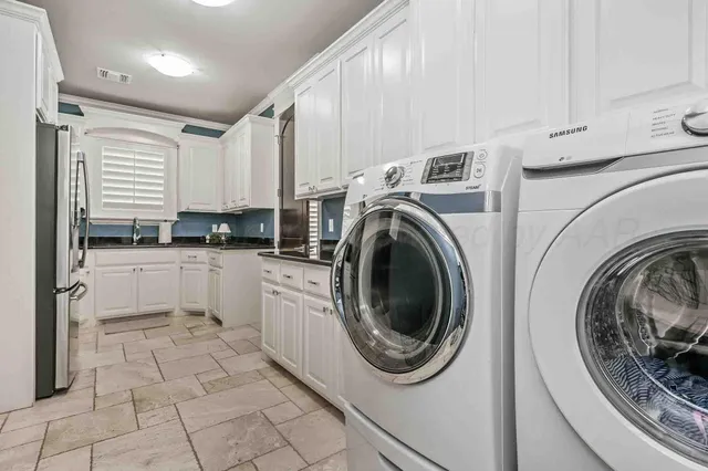 a kitchen with a washer and dryer in it