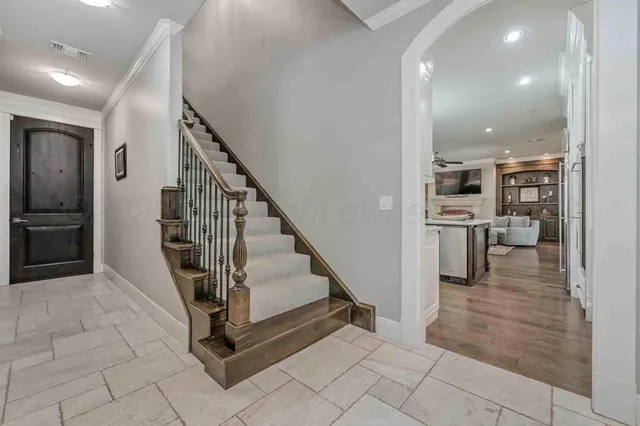 a view of a hallway with wooden floor and entryway
