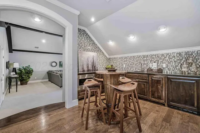 a kitchen with stainless steel appliances kitchen island granite countertop a table and chairs