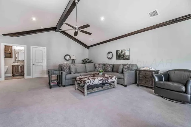 a spacious bedroom with a bed and furniture