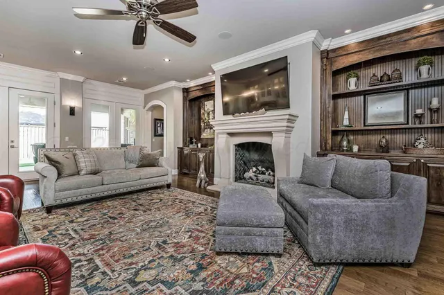 a living room with furniture a flat screen tv and a fireplace