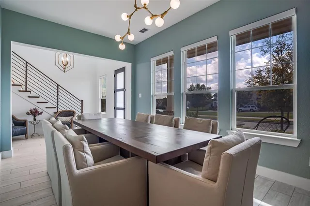 a dining room with furniture and wooden floor