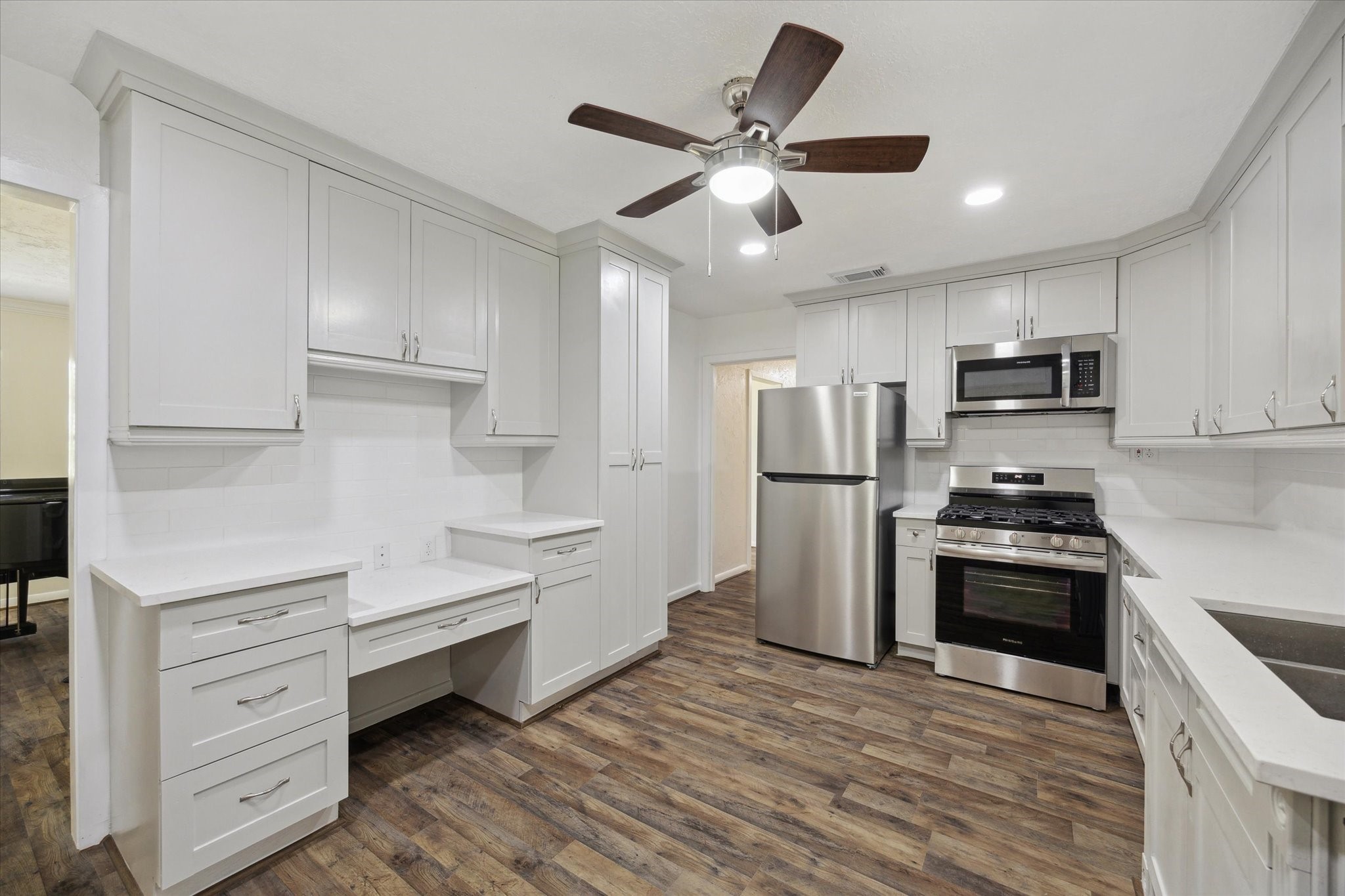 1309 Centennial Drive Houston, TX 77055 - Photo 11 of 33 a kitchen with stainless steel appliances a refrigerator stove and white cabinets