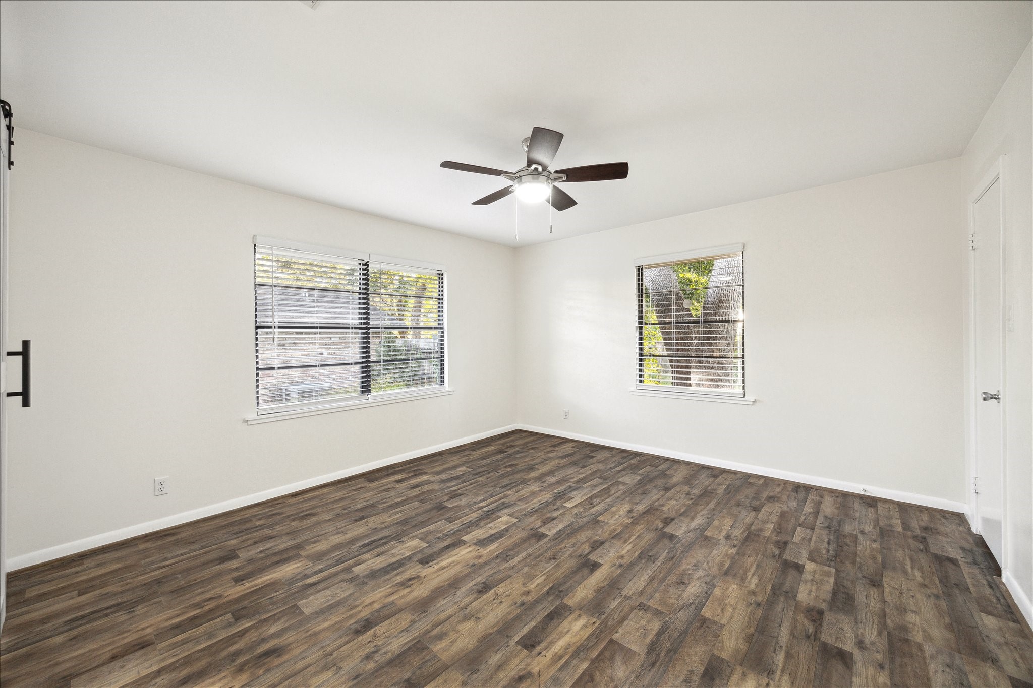 1309 Centennial Drive Houston, TX 77055 - Photo 14 of 33 a view of empty room with wooden floor and fan