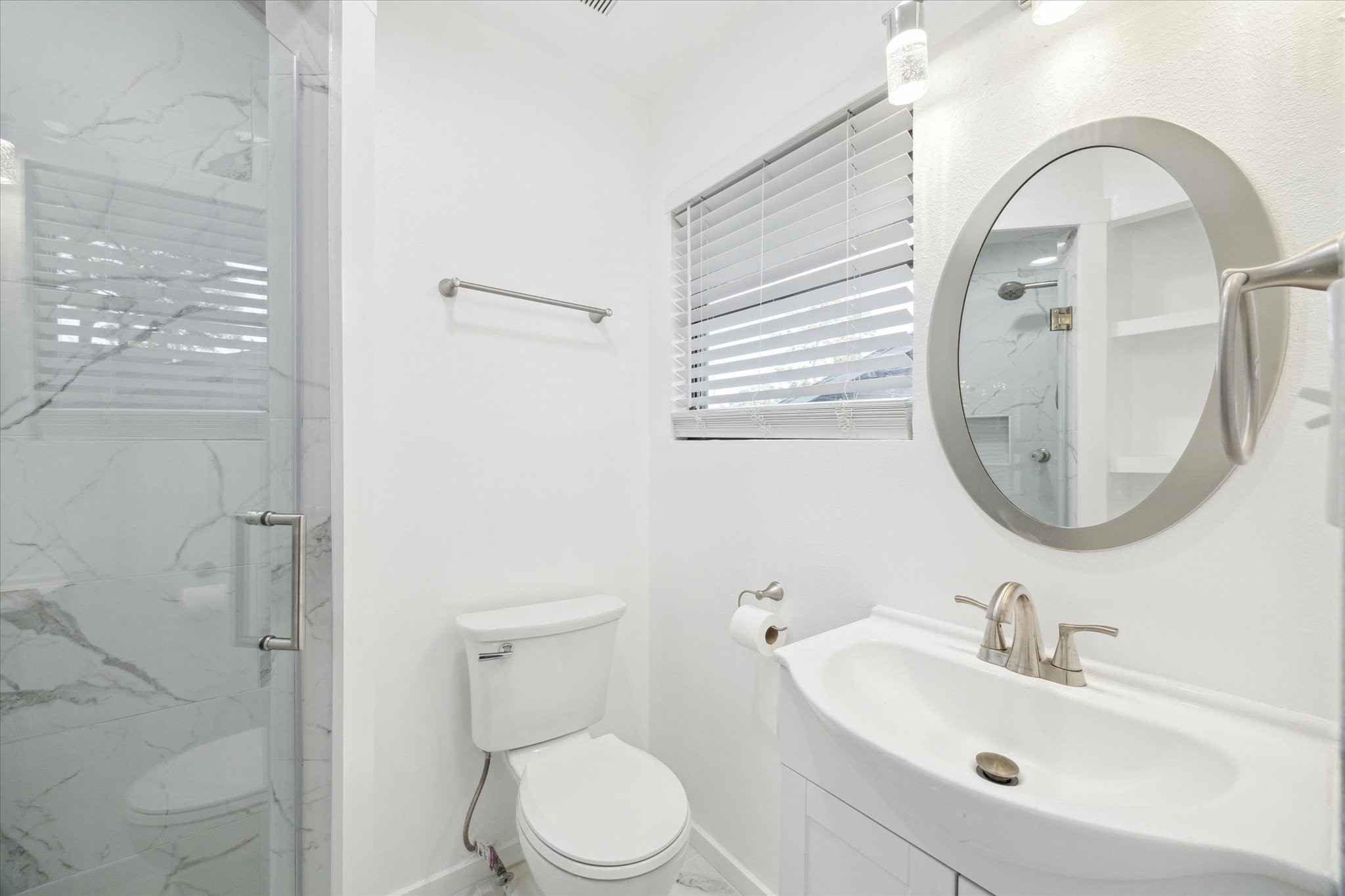 1309 Centennial Drive Houston, TX 77055 - Photo 17 of 33 a bathroom with a sink a toilet and a mirror