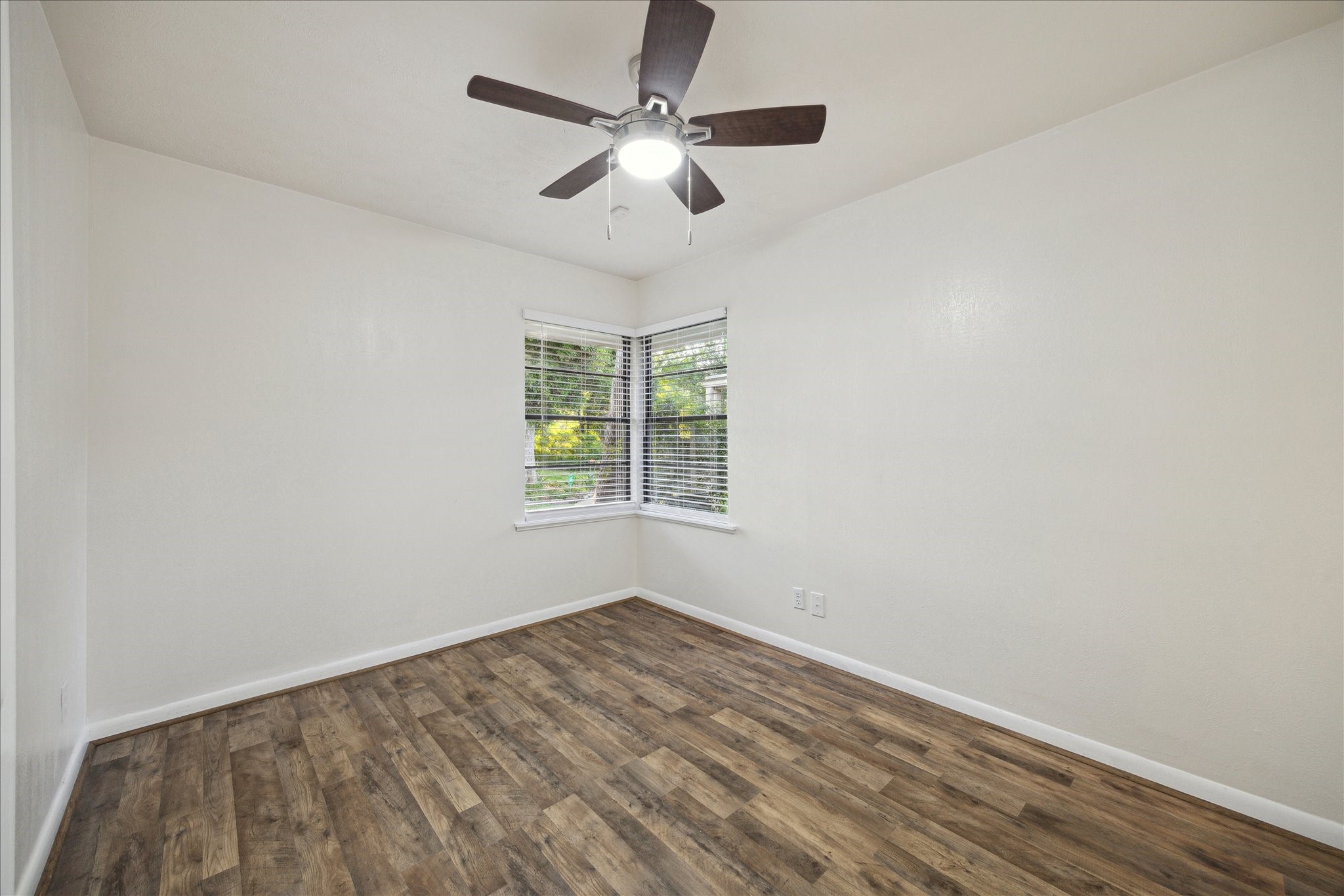 1309 Centennial Drive Houston, TX 77055 - Photo 18 of 33 an empty room with a window and a fan