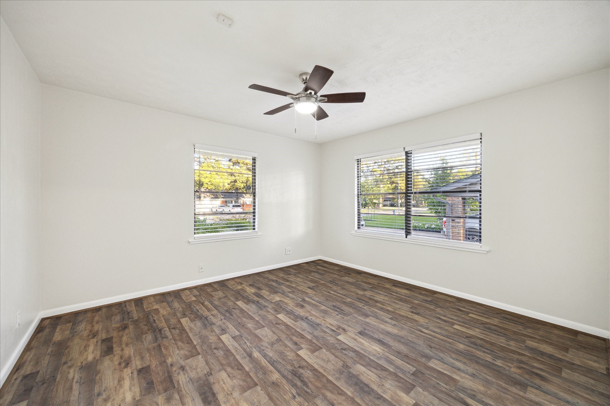1309 Centennial Drive Houston, TX 77055 - Photo 19 of 33 a view of empty room with wooden floor and fan