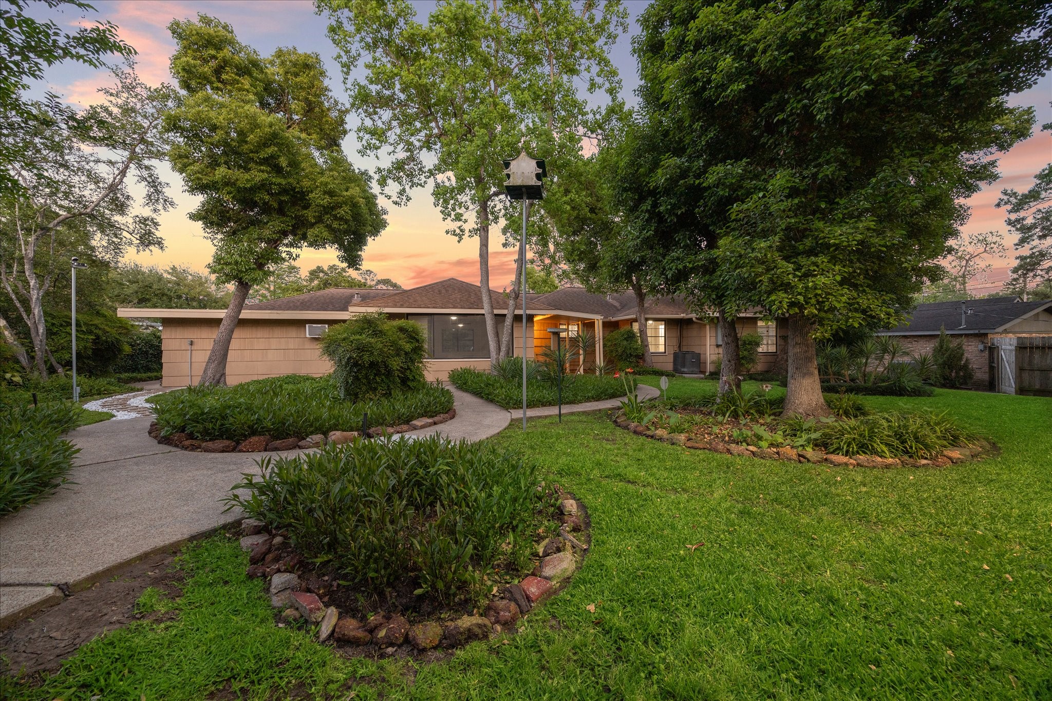 1309 Centennial Drive Houston, TX 77055 - Photo 30 of 33 a front view of a house with a garden