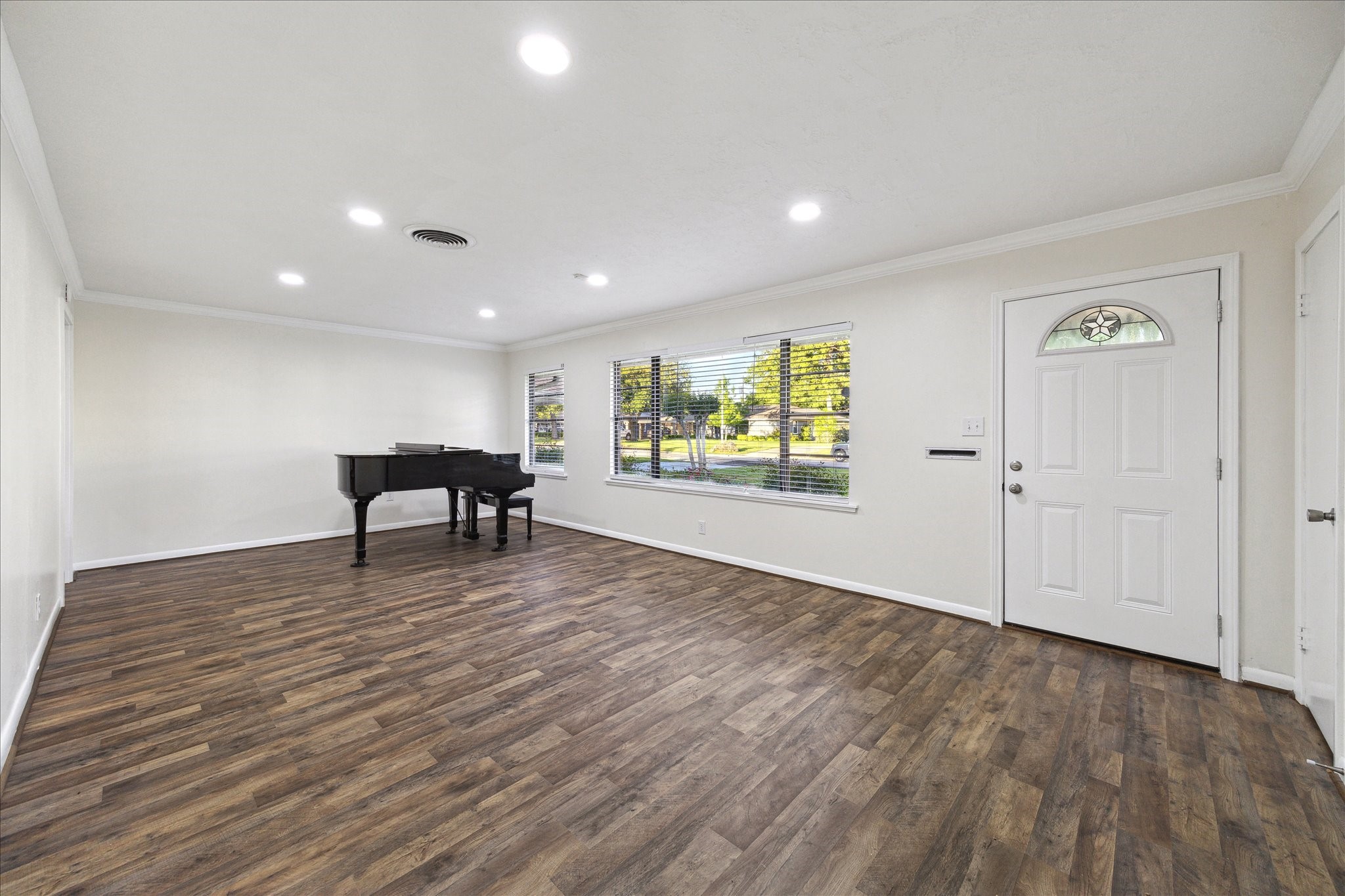 1309 Centennial Drive Houston, TX 77055 - Photo 6 of 33 a view of an empty room with window and wooden floor