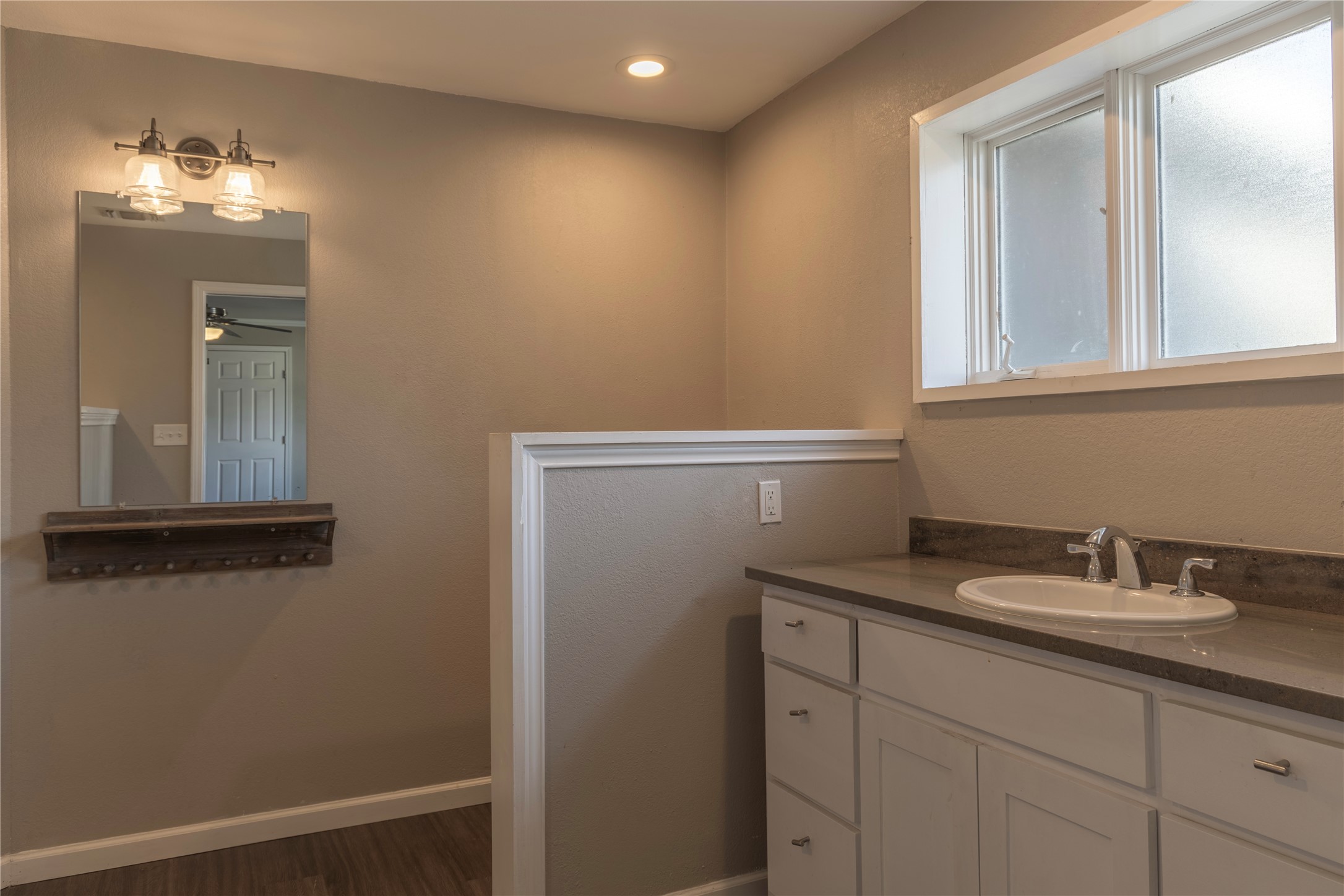 120 Erskine Ferry Road Seguin, TX 78155 - Photo 14 of 26 a bathroom with a sink a light fixture and a mirror